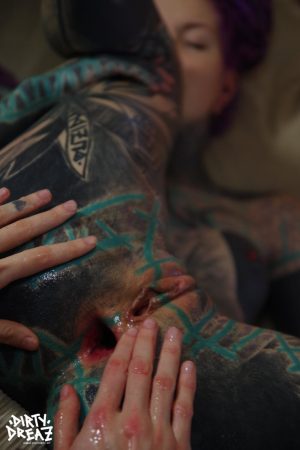 Heavily tattooed girl has her gaped anus fisted by her lover