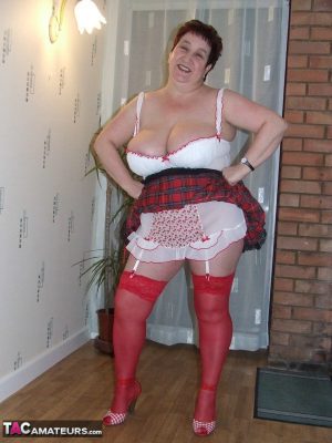 Fat amateur with short hair Kinky Carol exposes her huge tits in red nylons