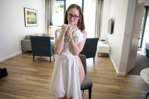 Ugly British girl Eva May gets naked on a chair in pigtails and glasses
