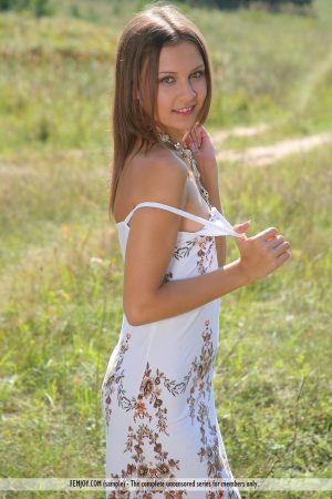 Petite white girl Rita B models naked in a farmer's field