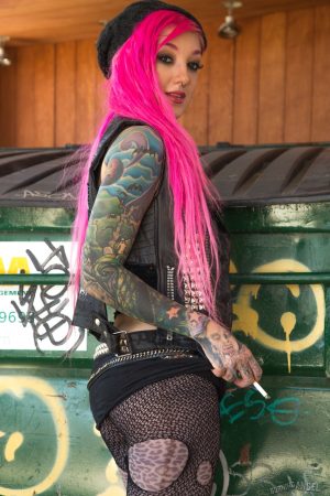 Smoking tattooed Kelsi Lynn in ripped pantyhose flaunting naked ass in alley