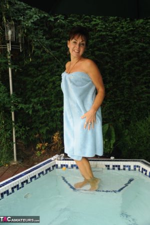 Mature lady Georgie relaxes her tan lined body in outdoor hot tub