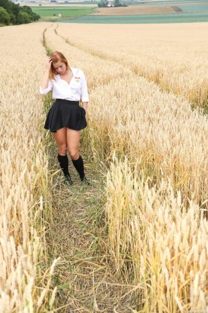 Blonde schoolgirl Chrissy Fox fingers her bald pussy amid a field of wheat