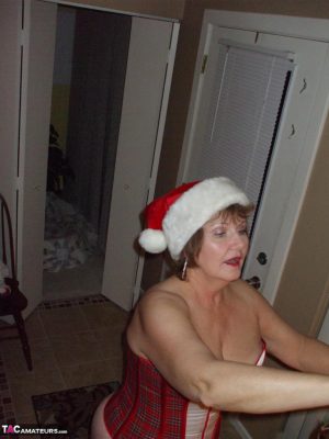 Mature amateur Busty Bliss displays her thong covered ass at Christmas