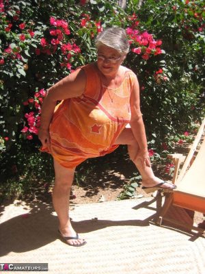 Obese granny Girdle Goddess strips to her sandals on garden patio