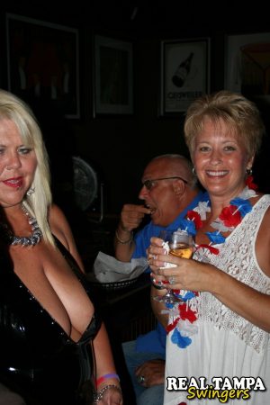 Slutty mature swinger wives expose their big tits & get naughty at a party