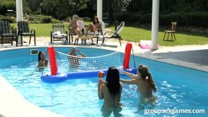 Lesbian girls play nude volleyball in a pool before daisy chaining on a lawn
