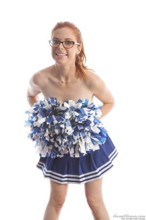 Cute redhead cheerleader Penny Pax in glasses baring big tits & firm ass