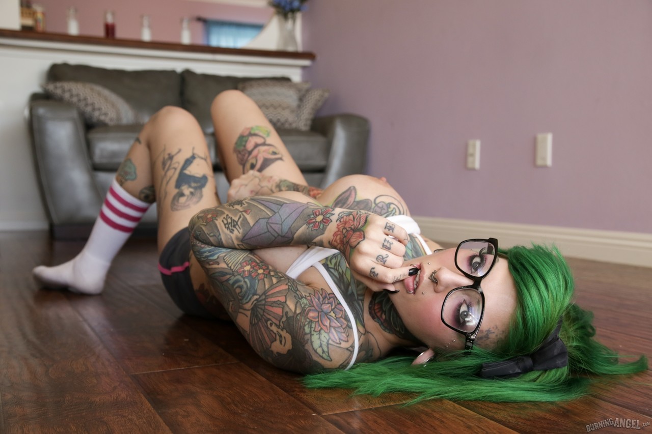 Green haired glasses wearing hottie exposes huge melons & spreads pussy lips