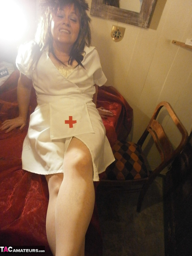 Mature lady Caro gest decked out in naughty nurse attire for a live cam show